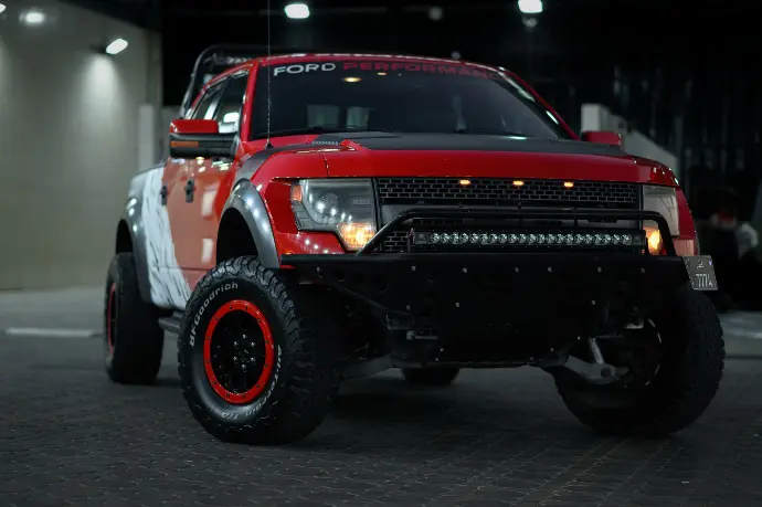 Red Ford Raptor Truck ford raptor fully customized with vinyl wrap, suspension, engine repair.